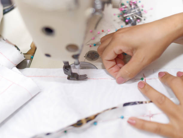 istock Hands of a tailor or designer Using machines to work in the studio 2149516860