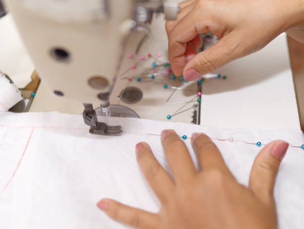 istock Hands of a tailor or designer Using machines to work in the studio 2149516865