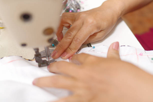 istock Hands of a tailor or designer Using machines to work in the studio 2149516870