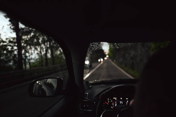 istock Driving car at night, personal perspective. 2149517376