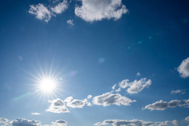 istock Bright summer sun in the blue sky with white clouds 2149518465