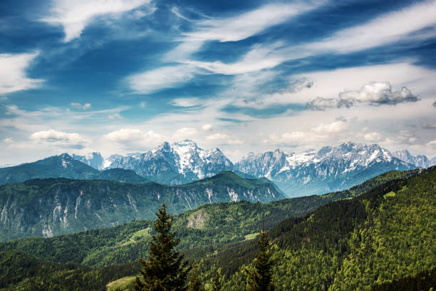 Landscape with cloud shadows over Triglav mountains - view from Golica mountain with green forest - travel summer seasonal concept