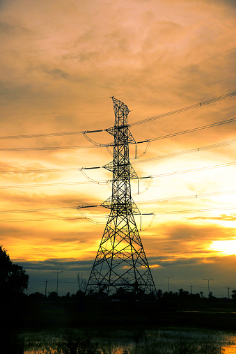 Vertical High voltage pole electric wiring distribution landscape energy engineering. Electricity energetic sunset green mountain in countryside. Vertical Electric power energy engineering industrial