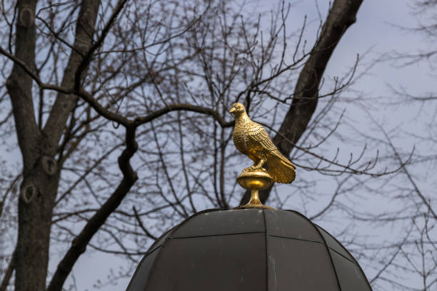 Golden bird sculpture atop a dome.