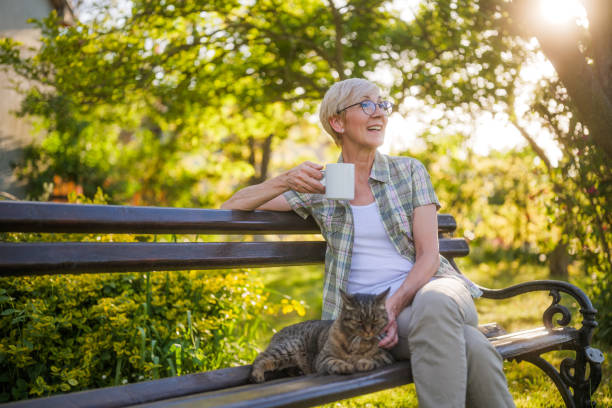 istock Senior woman drinking coffee and spending time with her cat 2149521612