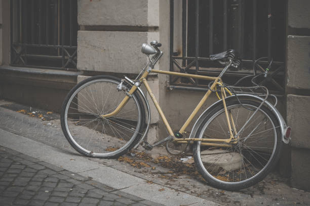 istock an old bicycle on the sidewalk in front of a house 2149523470