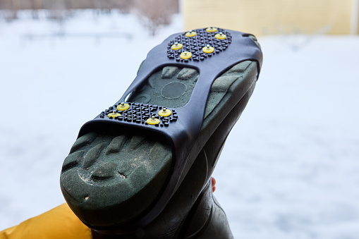 Studded overlay on sole of footwear will help prevent slipping on black ice and prevent injury.