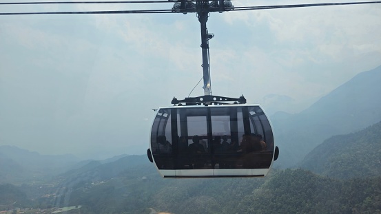 Cable car in the Fansipan mountain, Sapa town, Vietnam in the morning with foggy. Picture  adventure landscape. Nature background.