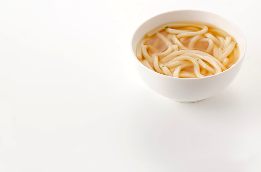 Japanese Kake udon noodles in a bowl on white background