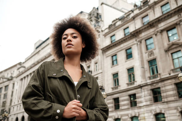 istock Serious curly woman posing in front of old building. 2149525791
