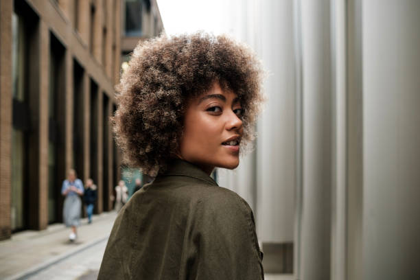 istock Back view of young female model looking at camera. 2149525809