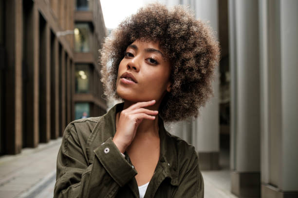 istock Relaxed curly model posing in a narrow street. 2149525810