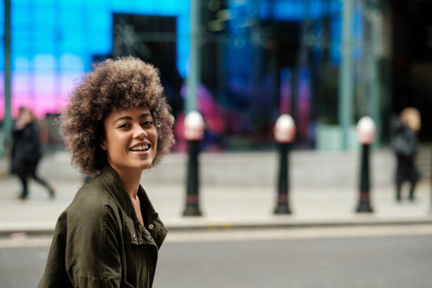 istock Cheerful woman posing in front of blue neon wall. 2149525846