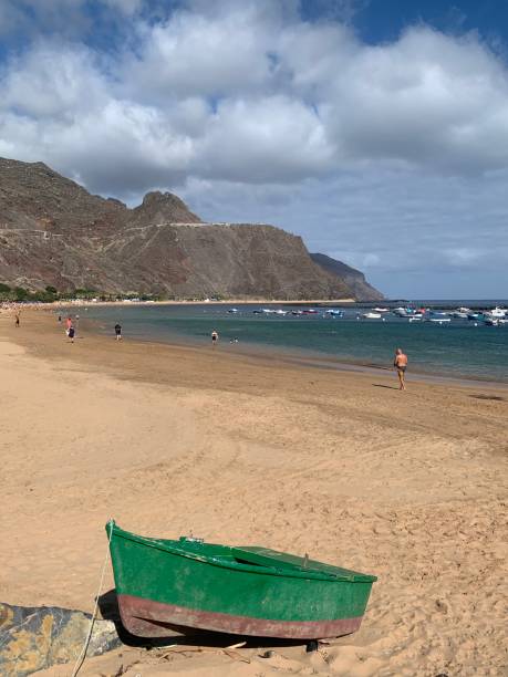 istock Green boat on golden beach Tenerife 2149525933