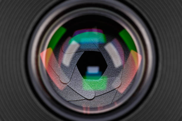 Macro close up of a camera lens with vibrant colorful light reflections and bokeh. Abstract view inside the optical glass with rainbow hues, ideal for technology, photography, and creative concepts.