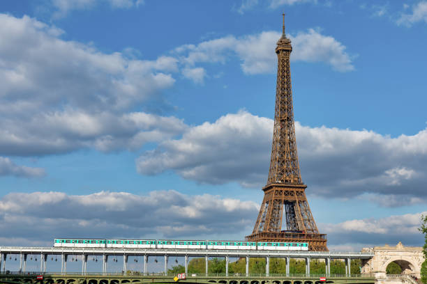 Paris Metro Crossing Iconic Steel Bridge with Eiffel Tower Background