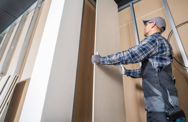 istock Construction Worker Fitting Piece of a Drywall 2149530735