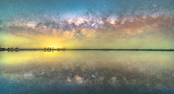 the milky way settled down to the lake, forming a reflected scene like a parallel world encountered.