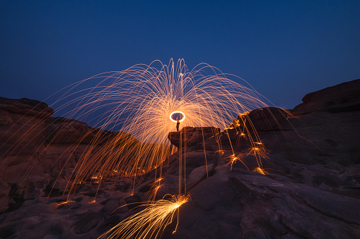 Burning steel wool fireworks, the grand canyon of Thailand (3000 bok) at Sam Pan Bok, Mekong River, Ubon Ratchathani, Thailand.