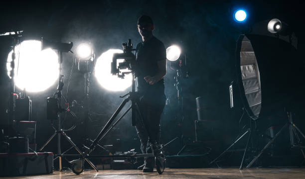 istock Photo Studio Worker Preparing Professional Lighting Equipment 2149531065