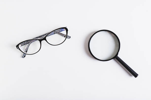 istock Choosing between vision glasses and a magnifying glass, top view 2149533281