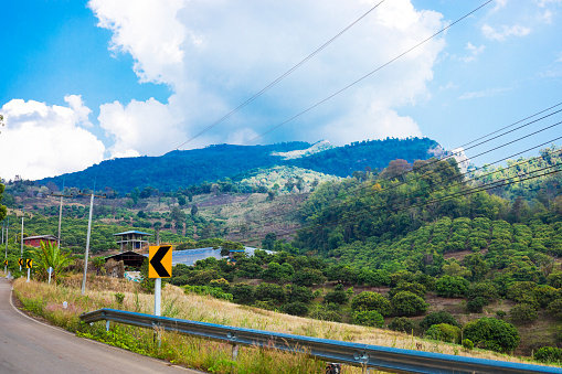 Road and view into mountain landscape around Pang Kha in north Thailand with Royal Development Center and coffee plantations in mountains around Phayao