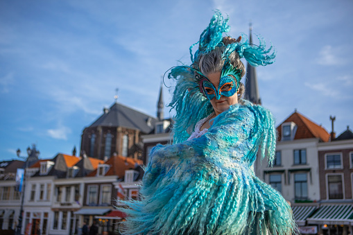Beautiful senior woman dancing in fancy dress for Carnival in delft