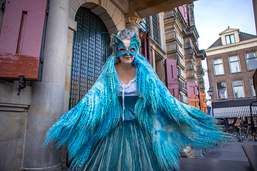 Beautiful senior woman dancing in fancy dress for Carnival in delft