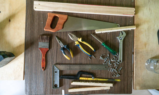Home renovation and construction concept with work tools in house shape on the grass