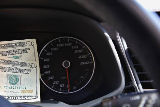 istock Some dollar on the speed indicator in a car 2149537386