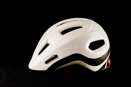 A white helmet with black stripes on it. The helmet is a safety gear for the head