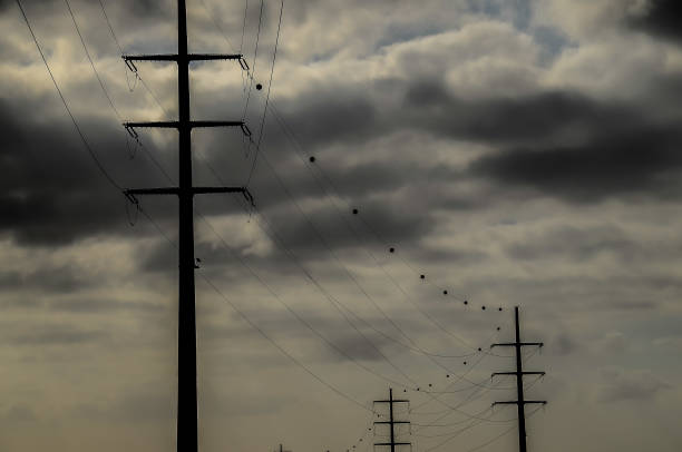 High voltage tower and transmission lines at sunrise