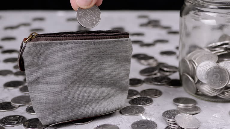 Woman Putting Some Cents into a Small Change Grey Purse. Close-up. Zoom