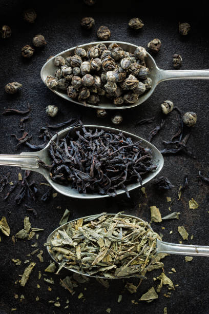 istock Various types of dried tea on spoons on a black background 2149538289