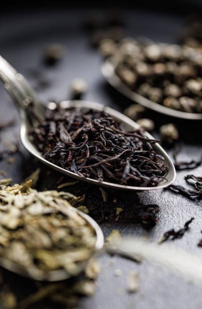 istock Dried tea on spoon on a dark background, focus on a spoon inside 2149538294