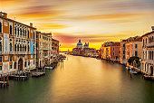 Sunrise colors of Grand Canal and Basilica di Santa Maria della Salute, very long exposure view from Accademia bridge, Venice, Italy
