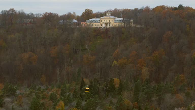 Krimulda Manor Across the Valley Among Autumnal Trees and Aerial Tram.
