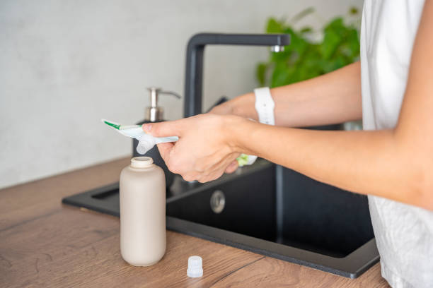 istock A woman pours soap or detergent from recycled packaging into a reusable bottle. Eco-friendly lifestyle concept 2149540635