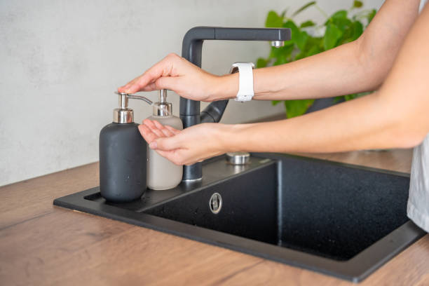 istock A woman uses soap or detergent from reusable bottle. Eco-friendly lifestyle 2149540661