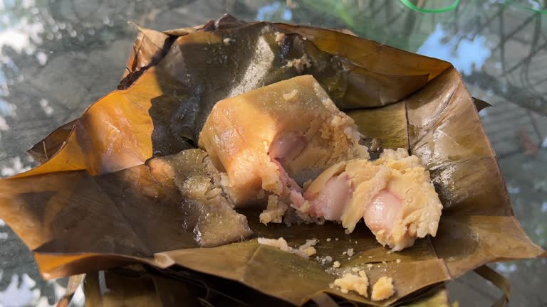 New Year rice cake Vietnam Vietnamese Chung Cake glutinous sticky rice cake, stuffed with pork meat, green beans and wrapped in bamboo leaf. Traditional Vietnamese New Year Tet food.