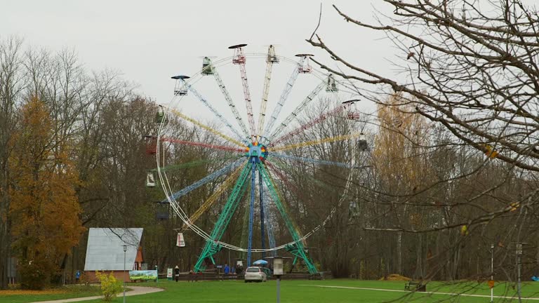 Colorful Ferris Wheel Turns Slowly on the Outskirts of Sigulda in Late Autumn.
