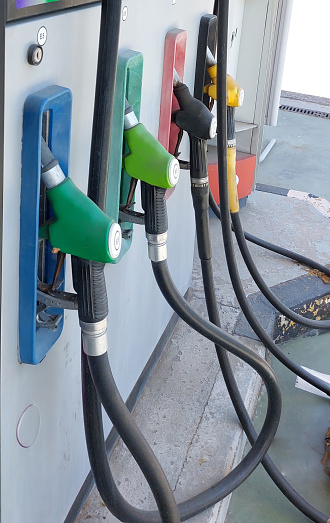 A gas station with different colored pumps. Gasoline, diesel of different octane ratings.3