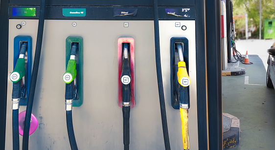 A gas station with different colored pumps. Gasoline, diesel of different octane ratings.