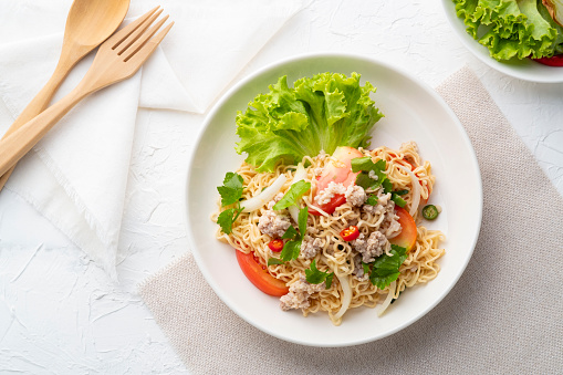 instant noodle spicy salad.Thai hot and sour noodle salad with minced pork that is very flavorful and addictive.Top view