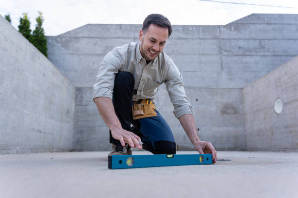istock Civil engineer on a construction site measuring with level, pleased with how the work is progressing 2149549042
