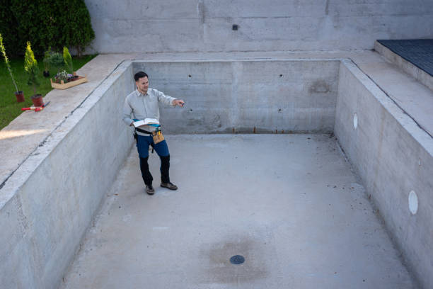 istock Civil engineer on a construction site holding blueprints and project plans while carefully observing the progress of the work 2149549095