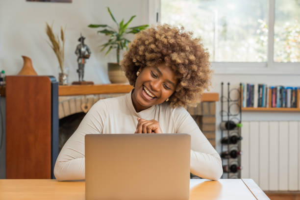 istock Mixed race woman sitting using her laptop 2149549734
