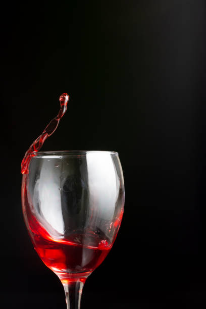A stemware wine glass filled with a rich red liquid, showcasing its deep color and enticing aroma. This elegant barware is perfect for savoring a dessert wine or any other alcoholic beverage