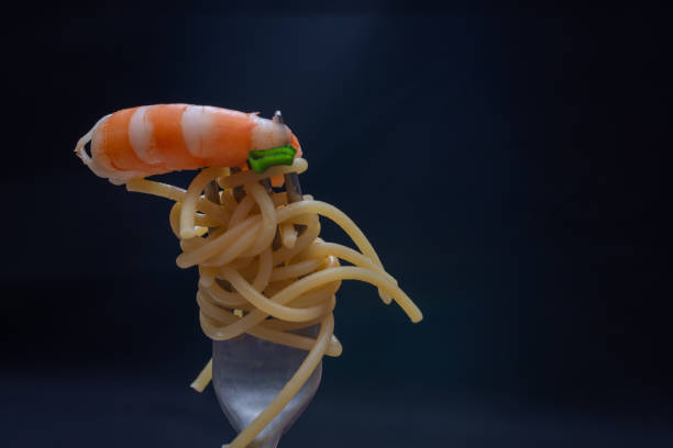 Spaghetti with shrimps and herbs on a fork