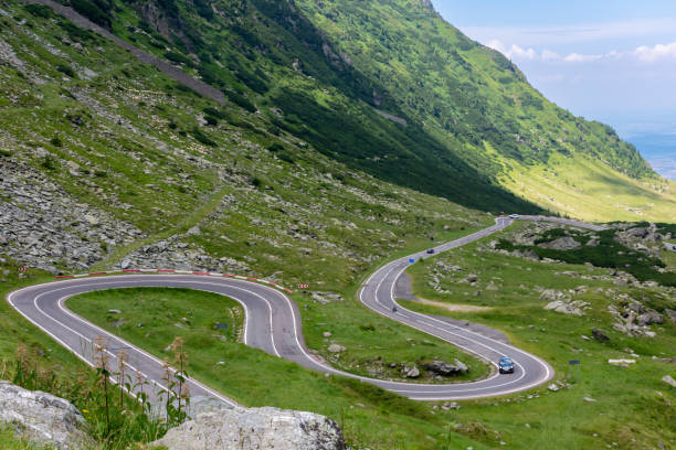 istock Car navigating mountain road with twists, surrounded by beautiful landscape 2149550220